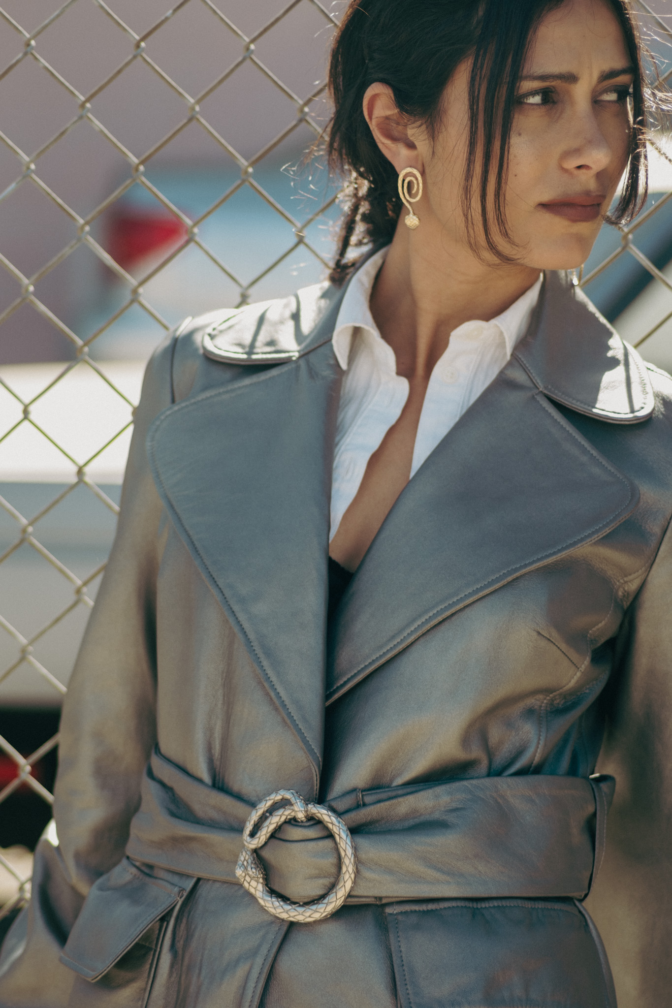 Silver leather trench, serpent spiral earring, glance away