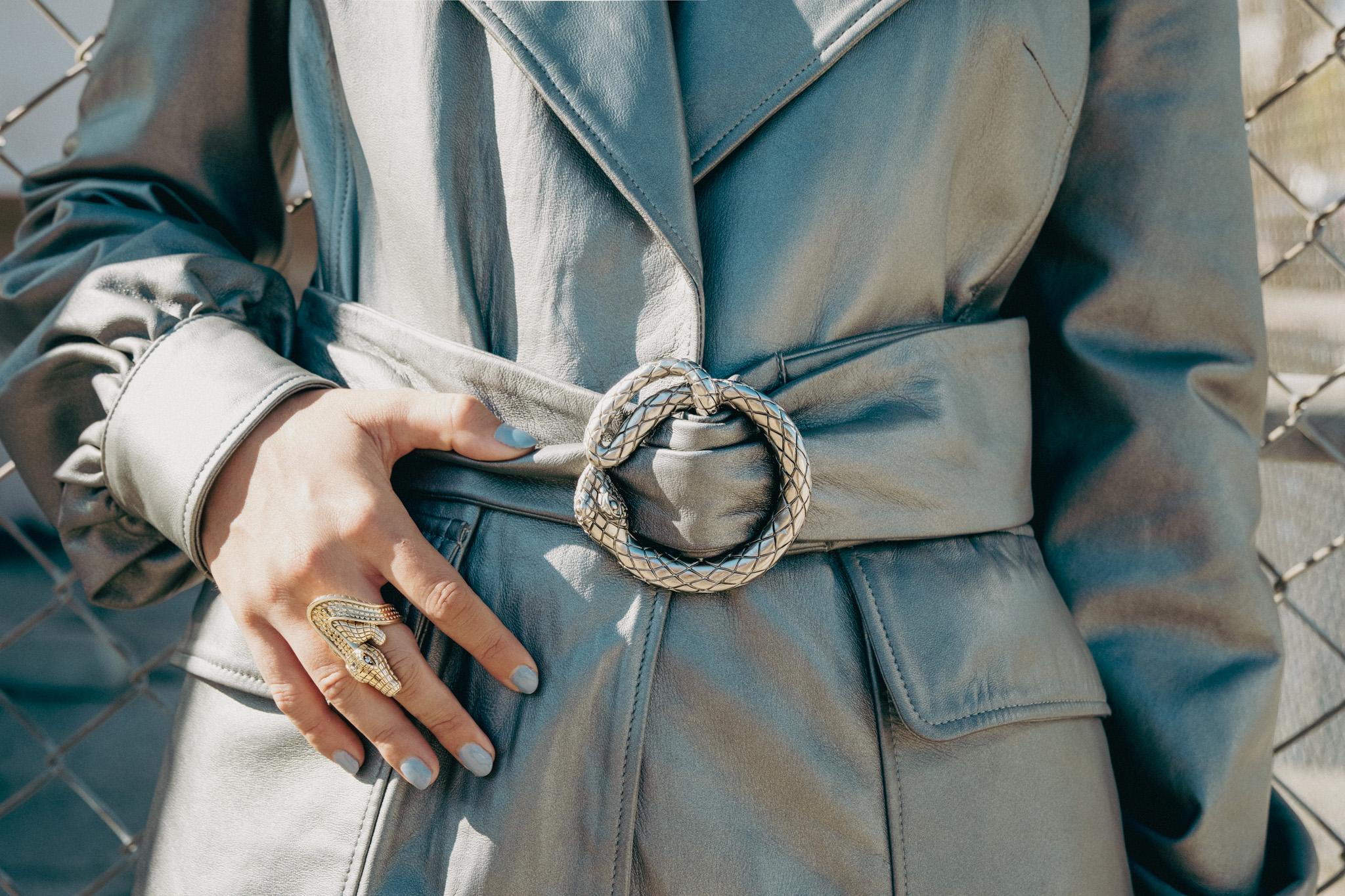 Silver serpent buckle, crocodile ring, hand at the waist