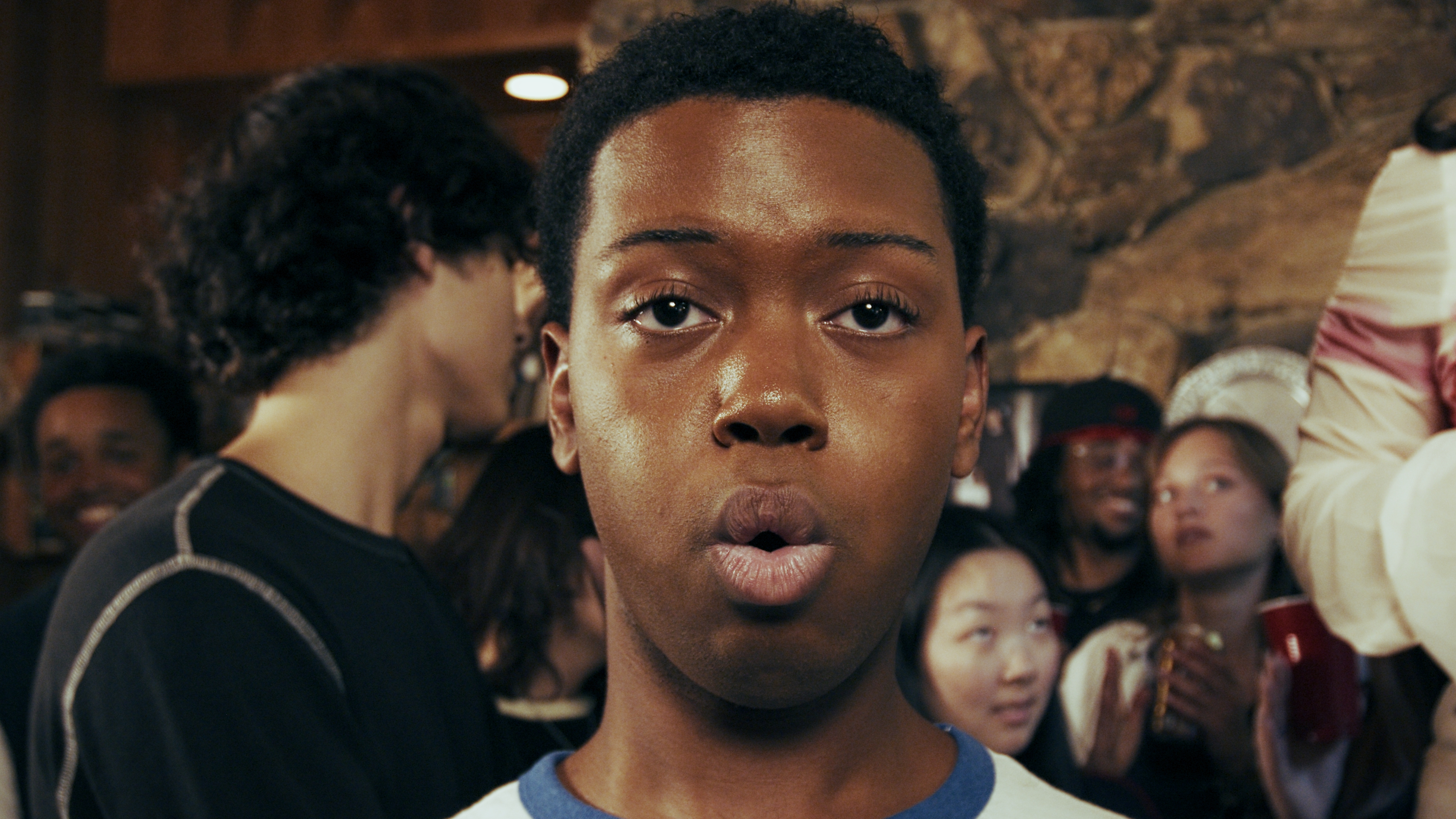 Lips pursed. The party behind him.