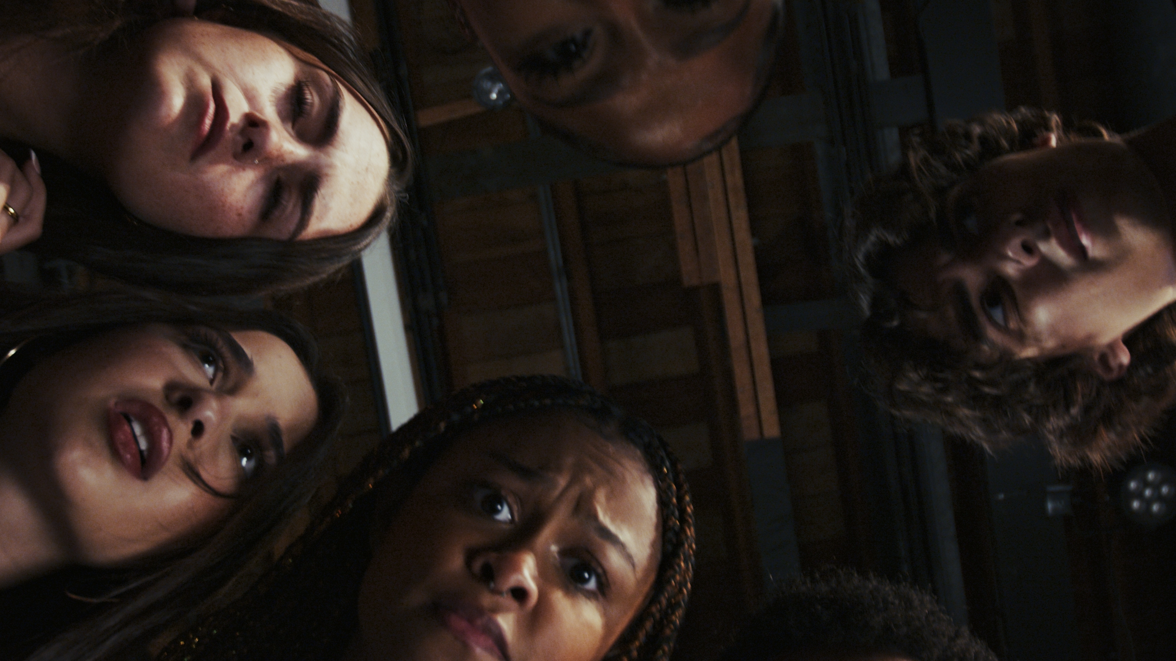 Looking up at a circle of faces.