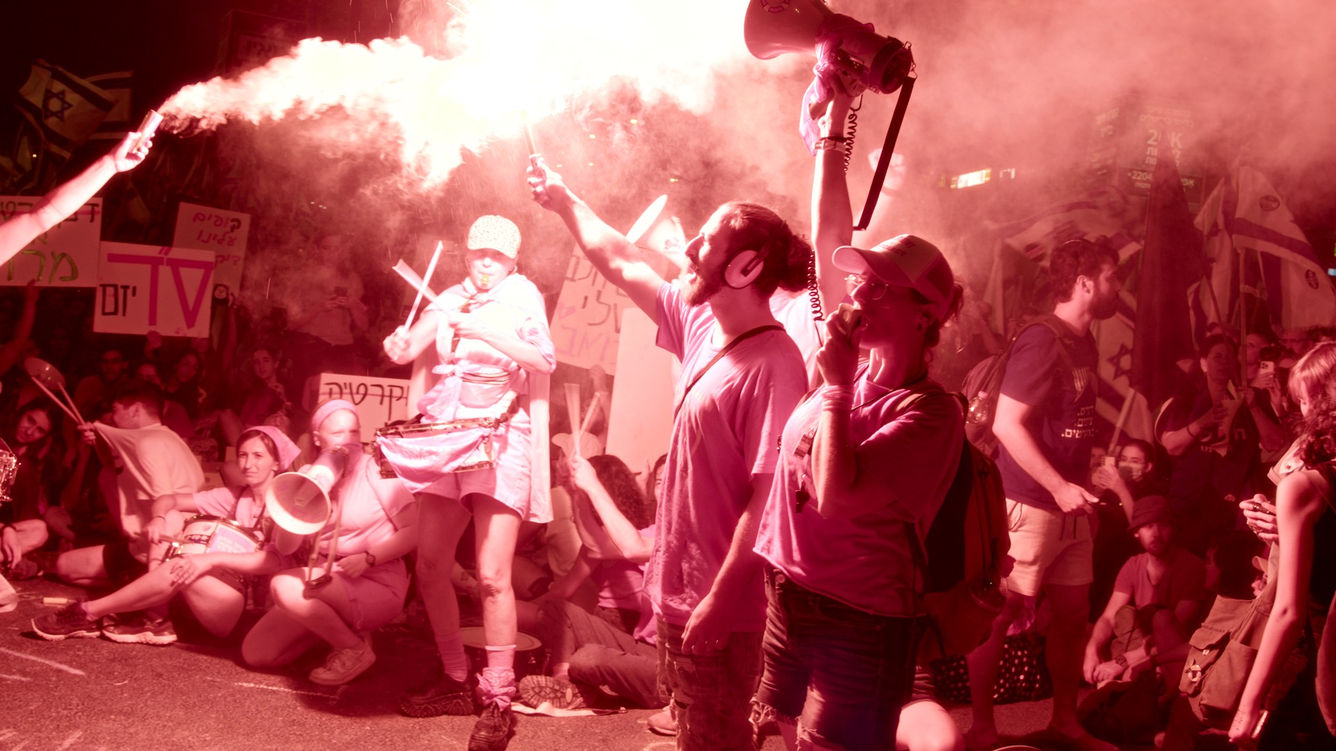 Night protest. Pink smoke, drums, megaphones.