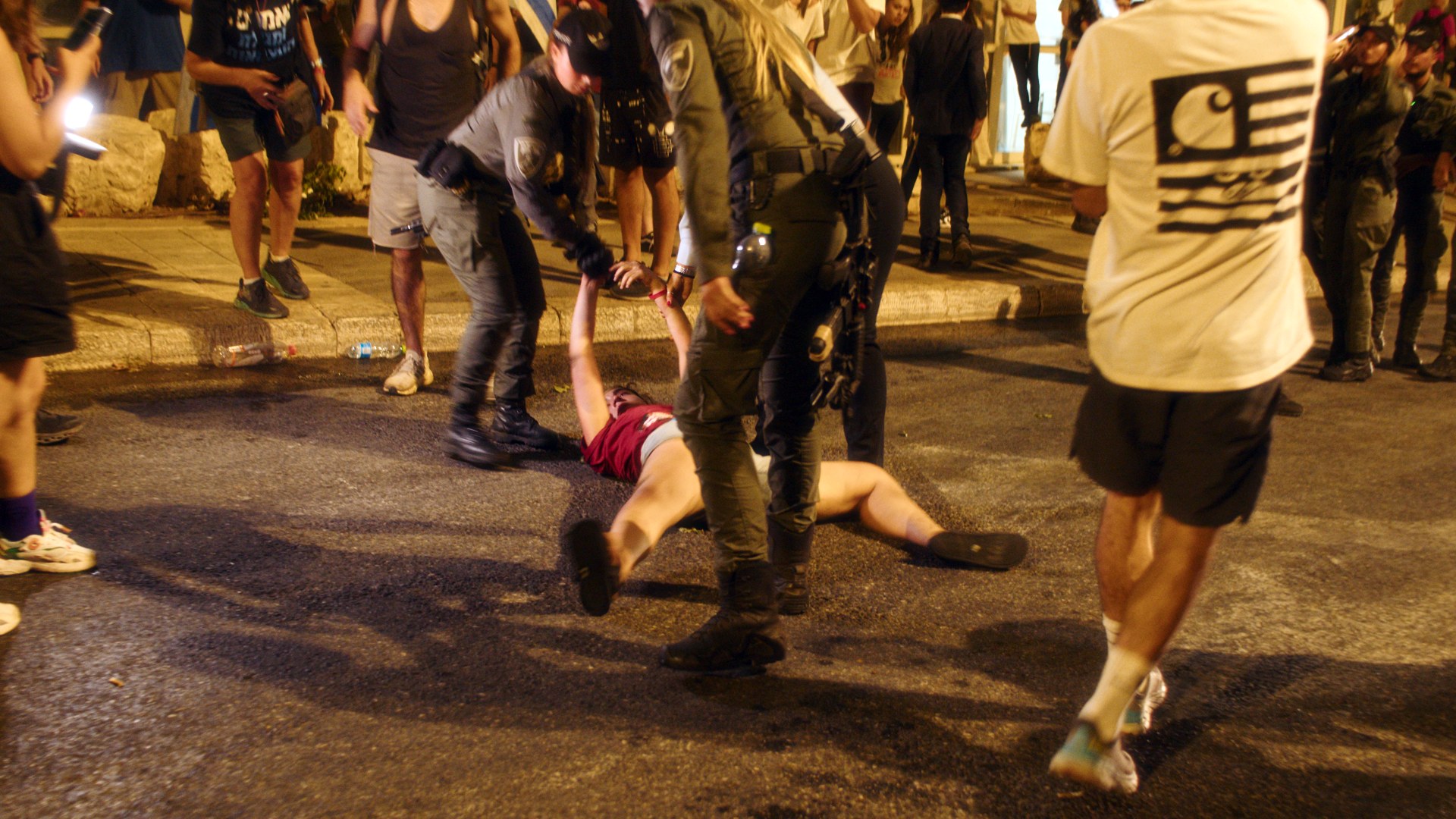 Arrest on the pavement, night.
