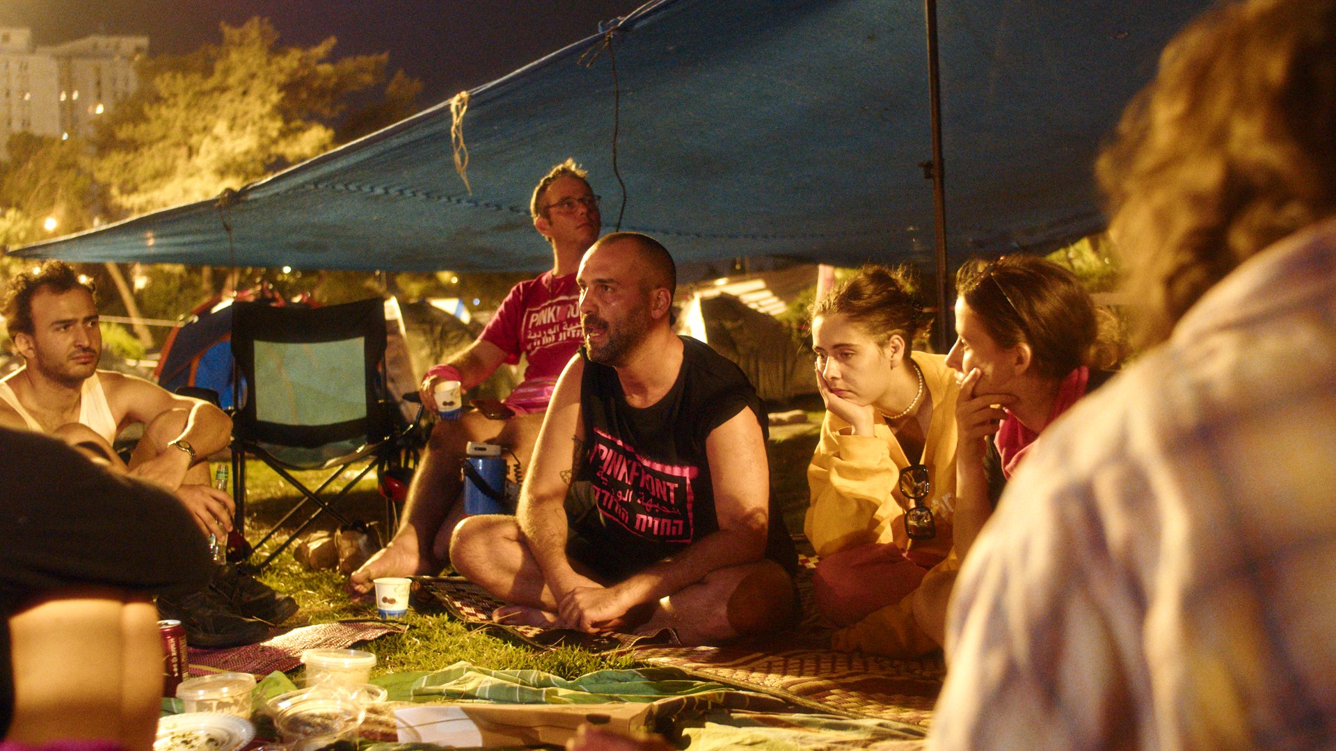 Encampment under a blue tarp. Late conversation.