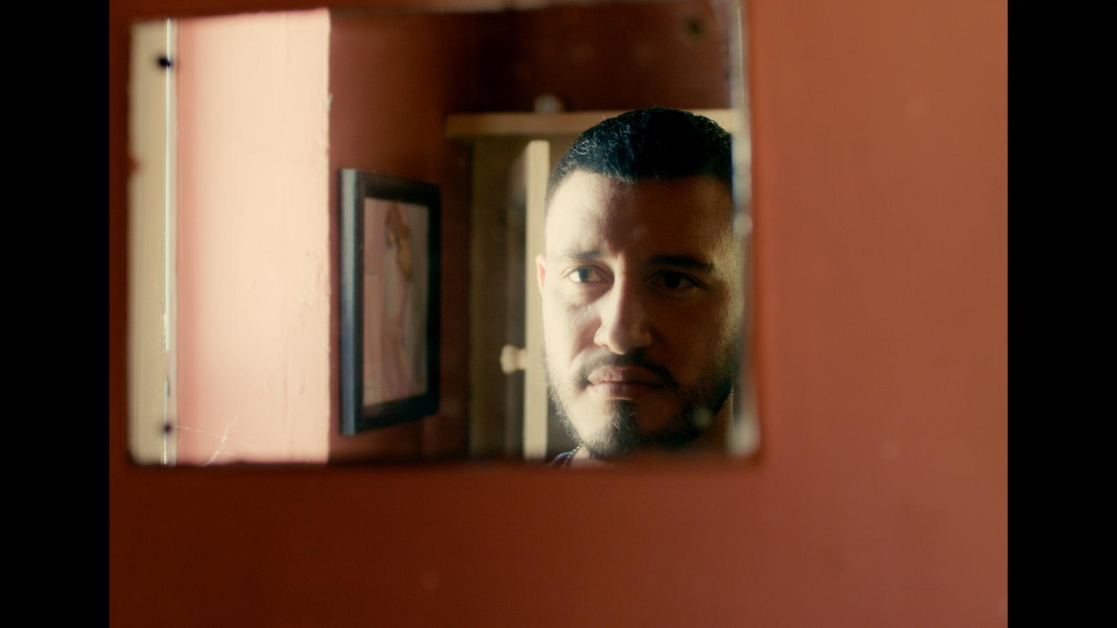 Reflected in a small mirror, red walls all around.